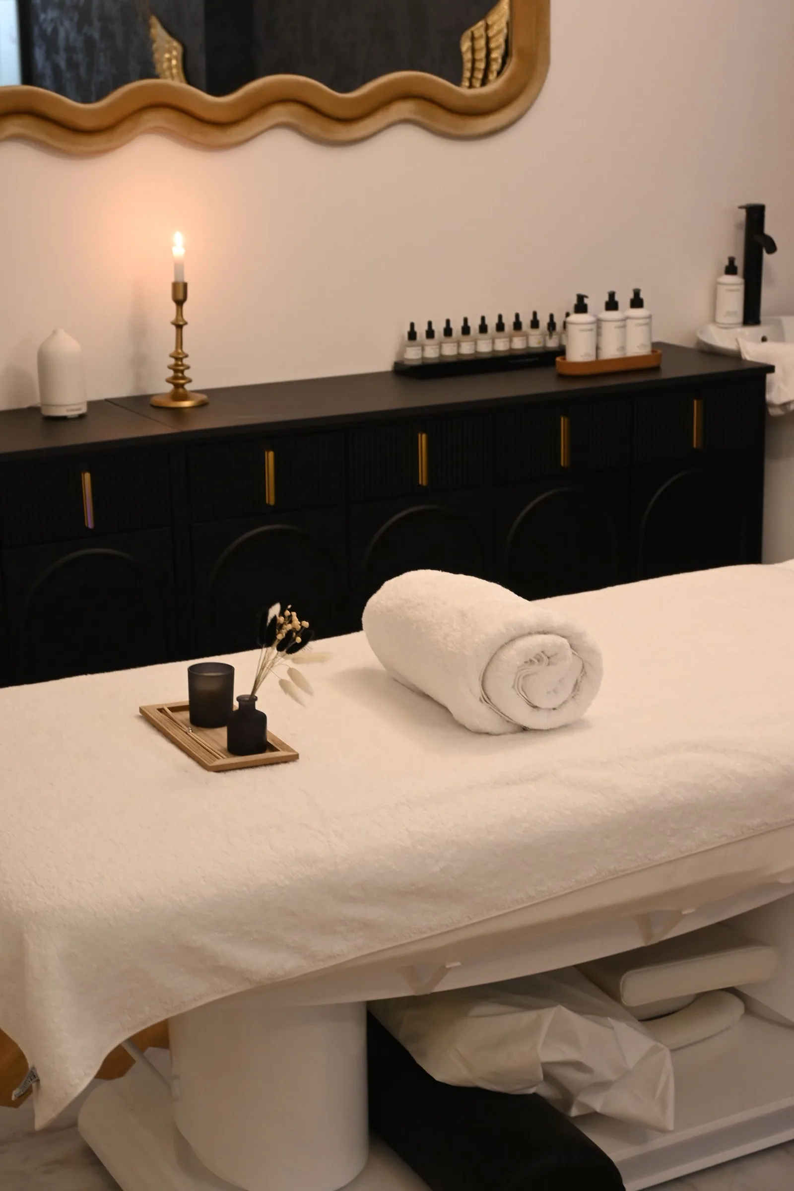 A calm treatment room prepared with towels and warm light