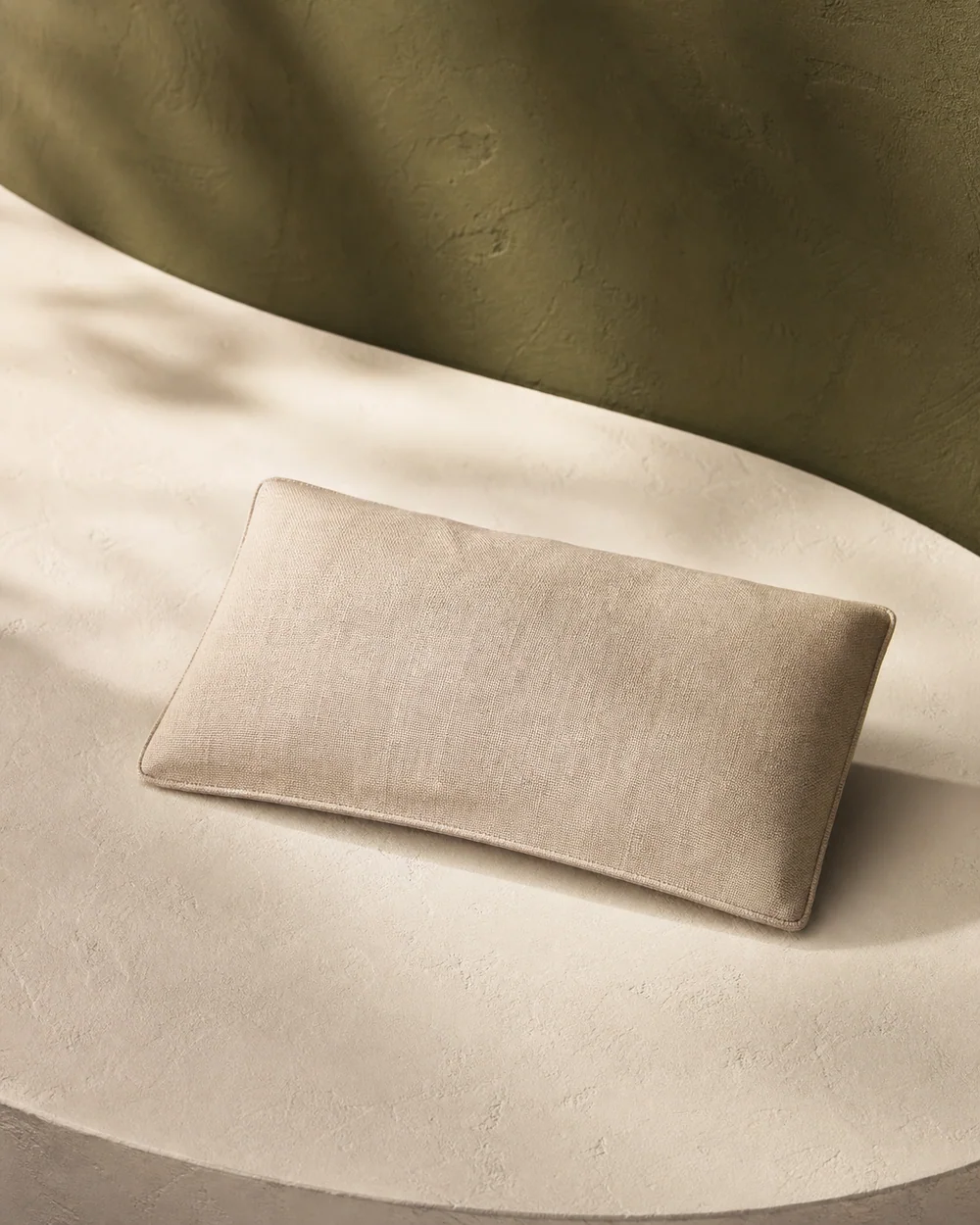 A softly weighted eye pillow in natural oat linen