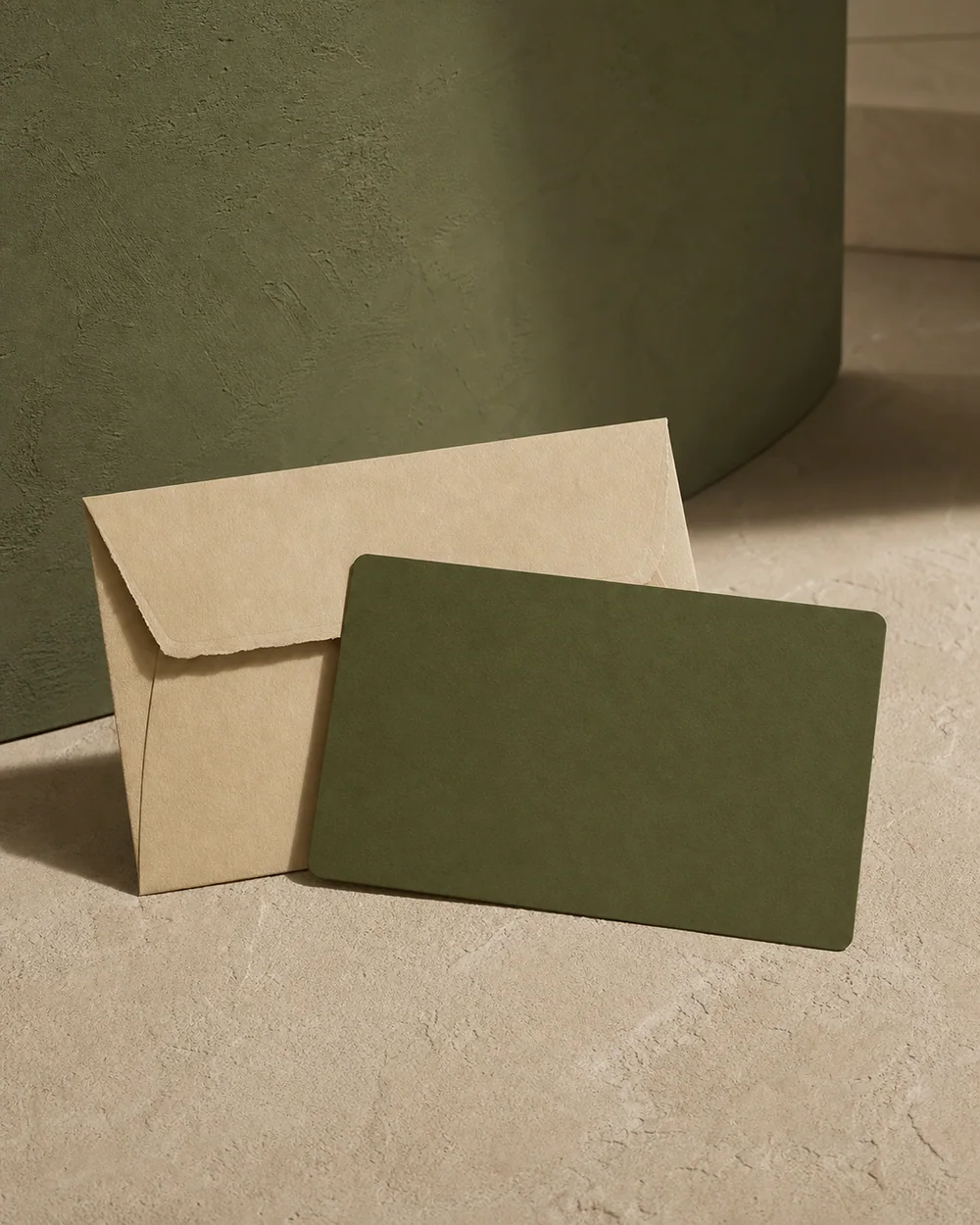 A blank moss gift card with an oat paper envelope