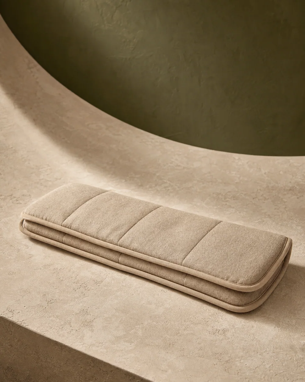 A folded quilted warming wrap in natural linen